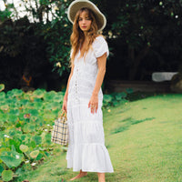 White The Srikandi Ruffle Maxi Dress by BrunnaCo, featuring flowing fabric and ruffle details, perfect for elegant summer wear.