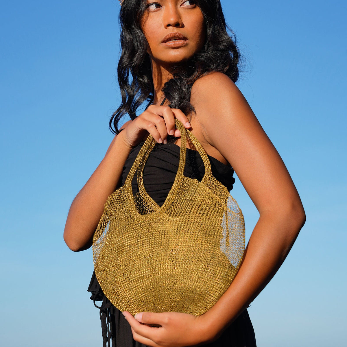 Dark gold Sol Mesh Wire Tote Bag by BrunnaCo featuring a lightweight, open-wire design and sturdy handles.