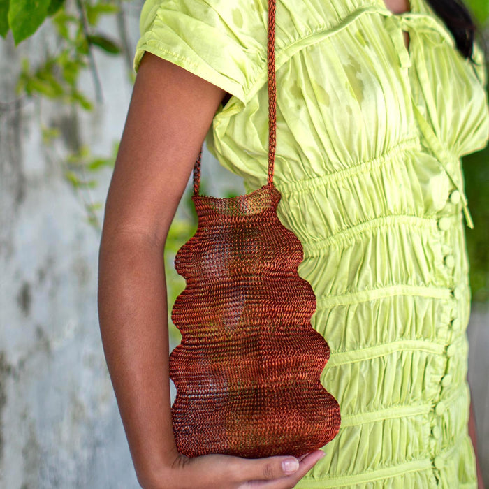 BrunnaCo Shell handwoven wire handbag in copper with intricate woven design and sturdy handle for stylish carrying.