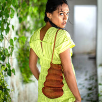 BrunnaCo Copper Shell Handwoven Wire Bag showcasing intricate wire craftsmanship and compact handbag design.