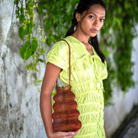 Copper BrunnaCo The Shell handwoven wire handbag with intricate wire detailing and a rounded, stylish design.