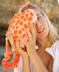 BrunnaCo Arnoldi Peachpuff clutch bag in orange and peach with glass bead detailing, stylish handbag for special occasions.