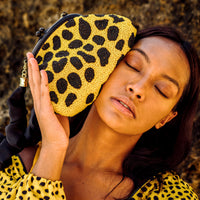 BrunnaCo Arnoldi Venom clutch bag with yellow polka dots, black accents, glass bead details, and compact handbag design.