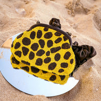 BrunnaCo Arnoldi Venom clutch bag in black and yellow with polka dots and glass bead accents, stylish handbag for evening wear.