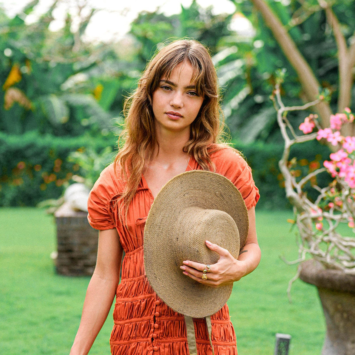 BrunnaCo Loli Jute Straw Sun Hat in neutral beige with wide brim, perfect for sun protection and stylish summer wear.