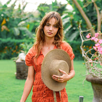BrunnaCo Loli Jute Straw Sun Hat in neutral beige with wide brim, perfect for sun protection and stylish summer wear.