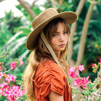 BrunnaCo The Loli Jute Straw Sun Hat in neutral beige with wide brim, perfect for summer and outdoor sun protection.