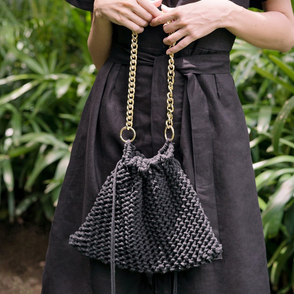 Black LYON macrame tote bag by BrunnaCo featuring intricate knotted design and sturdy handles for stylish carrying.