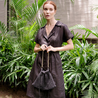 Black BrunnaCo LYON Macrame Tote Bag showing its woven design and sturdy handles on a neutral background.