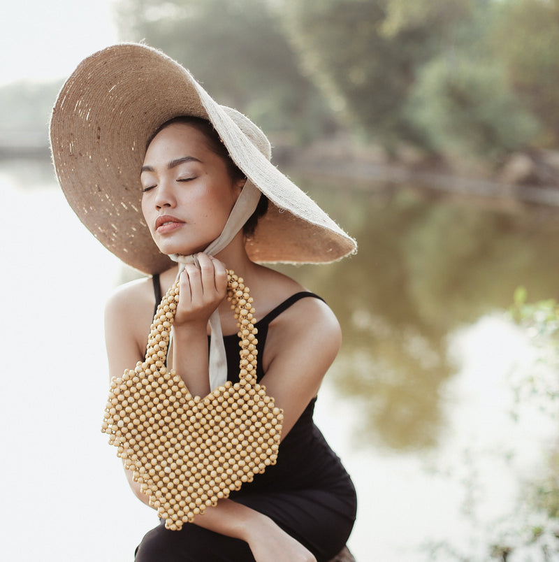 BrunnaCo Hati Heart wood-beaded tote bag with natural wood beads and spacious design for casual carrying.