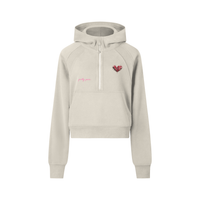 Women’s cropped PRETTY PAIN half-zip hoodie by Built From Pain, shown in black with a front half-zip and relaxed fit.