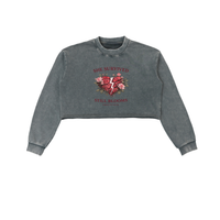 Built From Pain She Survived Still Blooms cropped sweatshirt with floral design and bold text on soft fabric.