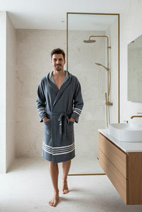 Man wearing a navy organic Turkish cotton short bathrobe with hood, lightweight Turkish towel robe by Buldano.