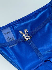 Royal blue Bunnies Room Iced Out G-String lingerie with sparkling details, shown on a model in a close-up view.