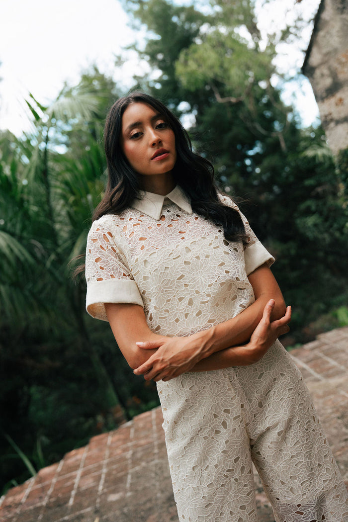 Carolina Sanz Remedios Top showing a stylish sleeveless design with a high neckline and vibrant printed fabric.