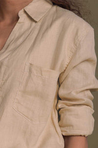 Neutral beige Meet Me by the Cliff Dress by DC-Reistor displayed on a hanger against a plain background.