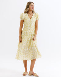 Downeast Sunshine State of Mind Dress in butter yellow with colorful sun and floral print, sleeveless summer dress.