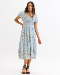Light blue multi-patterned Fresh Bouquet Dress by Downeast, sleeveless with a flowy, feminine silhouette and floral design.