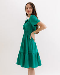 Downeast Icon Demi Dress displayed on a hanger, featuring a stylish, lightweight dress with a fitted bodice and flowing skirt.