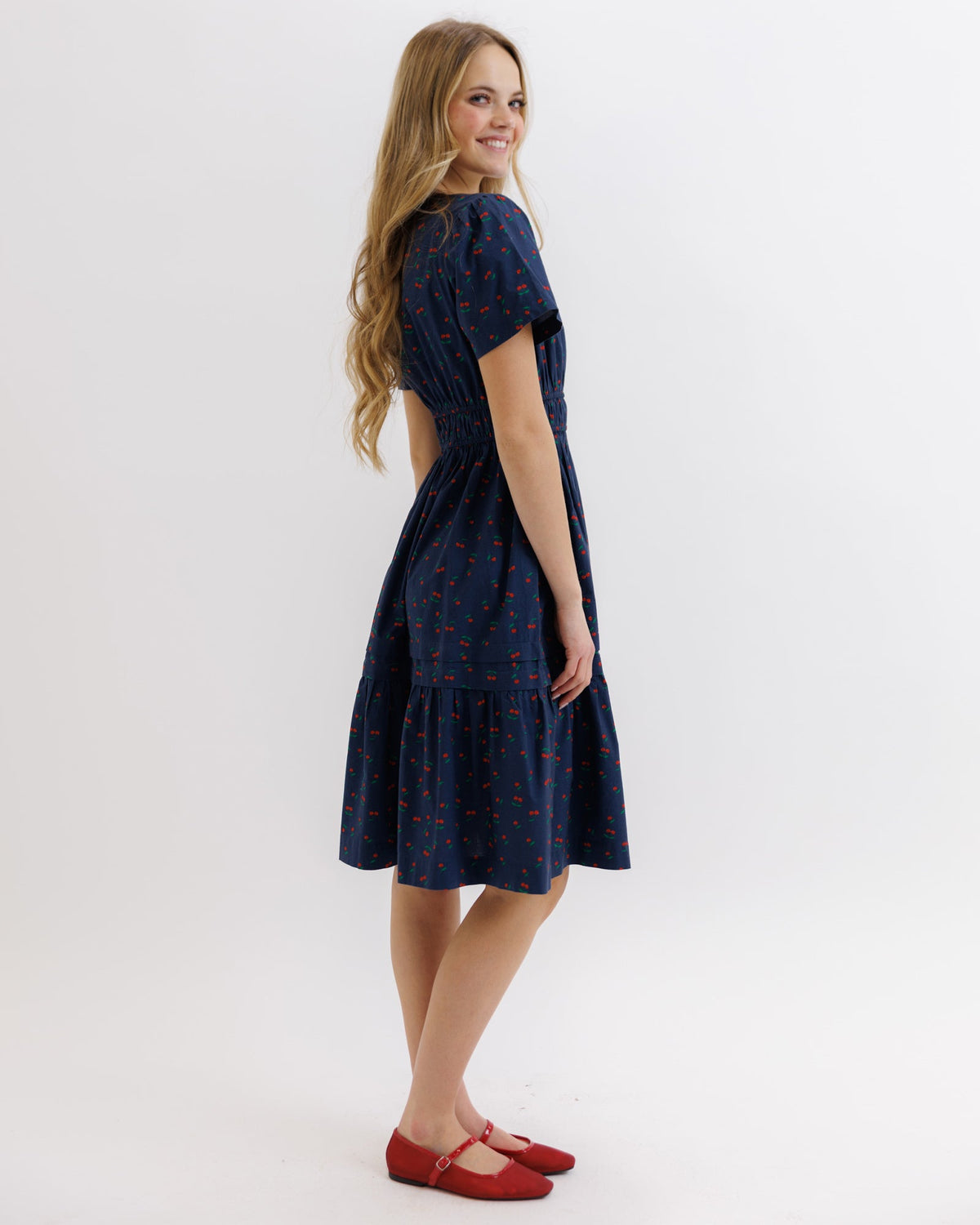 Downeast Icon Demi Dress displayed on a hanger, showcasing its elegant design and fabric details.