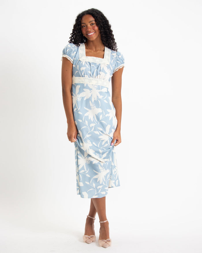 Downeast In Bloom Dress featuring floral pattern and flowy fabric, displayed on a hanger against a neutral background.