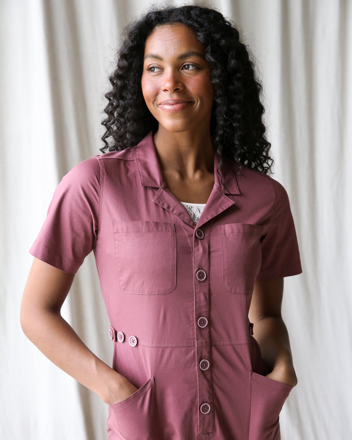 Downeast crushed berry utility jumpsuit featuring a relaxed fit, front pockets, and adjustable straps for casual wear.