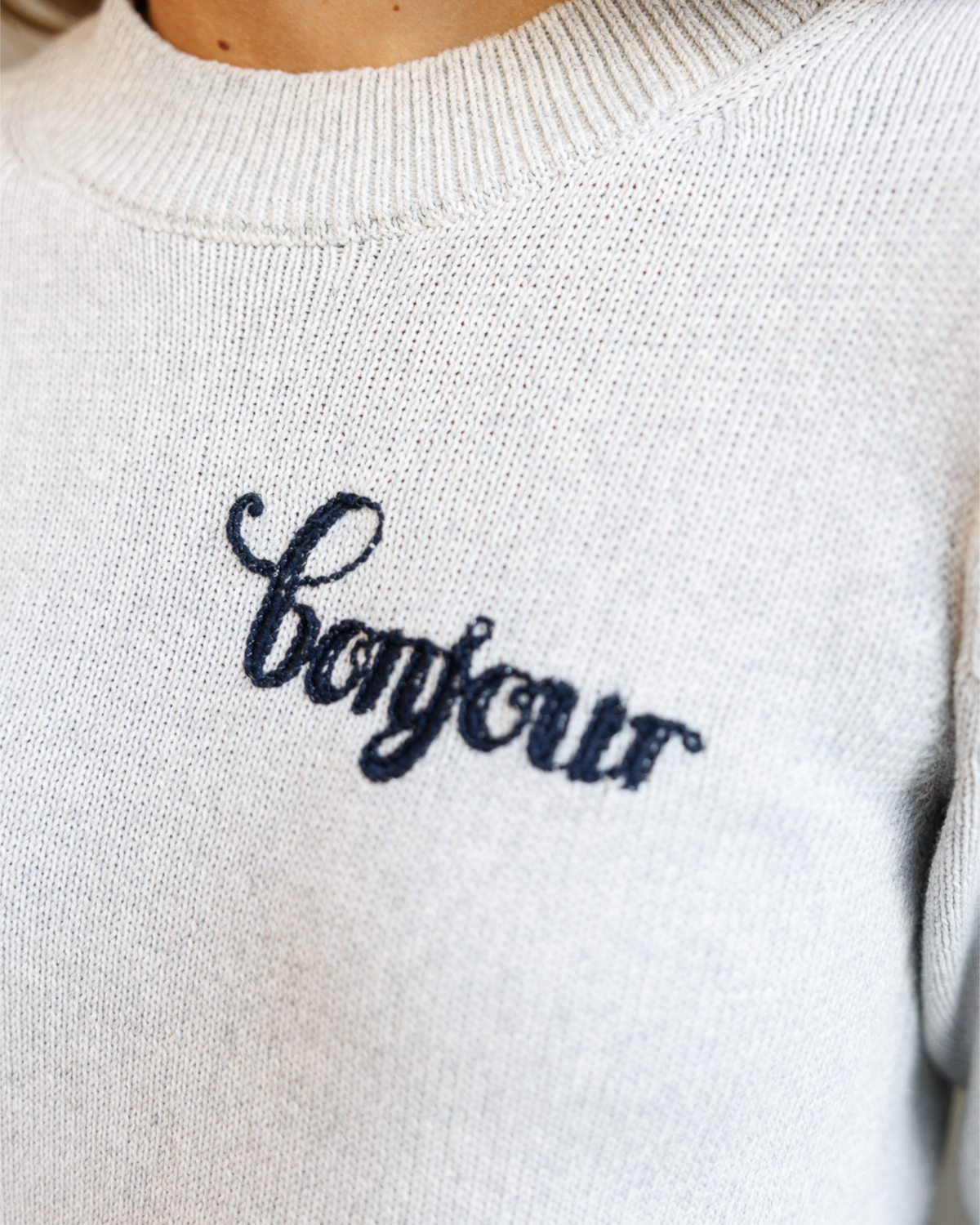 Downeast gray statement sweater for women, featuring a cozy knit design and relaxed fit.