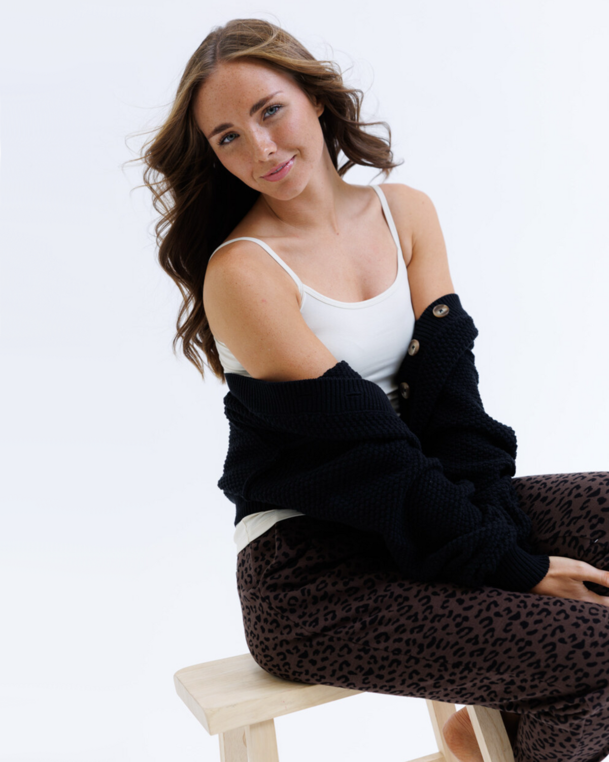 White Downeast Wonder Cami tee displayed on a hanger, showcasing a casual sleeveless top for women.