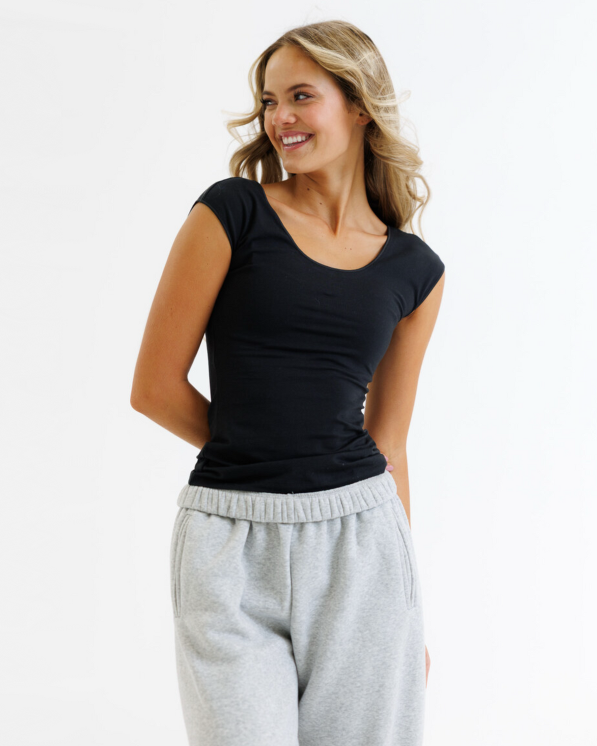 White Wonder Tee by Downeast, a casual short-sleeve cotton t-shirt for women, displayed flat with folded sleeves.