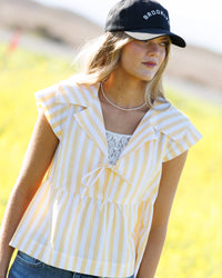 Downeast Sunshine Stripe Top for women, lightweight with vibrant yellow and white stripe pattern, casual chic top for warm days.
