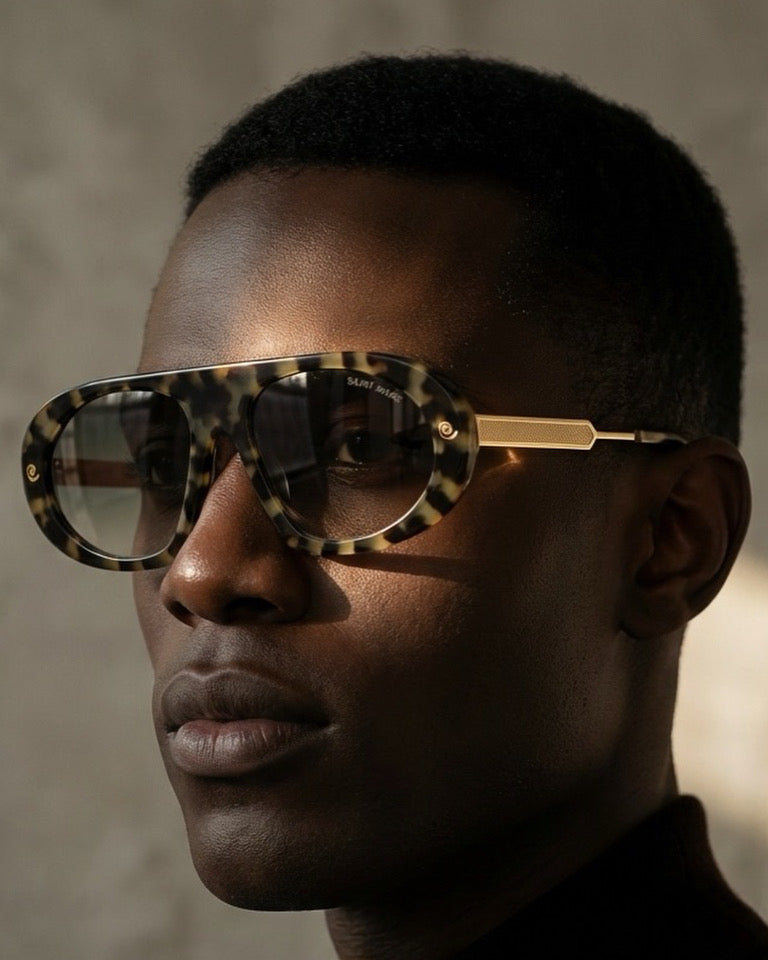 Black Saint Marc sunglasses with clear lenses by Exclusive Eyes Inc, showcasing stylish eyewear design.