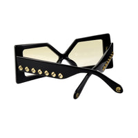 Elegant Madame X eyeglasses by Exclusive Eyes Inc with sleek black frames and clear lenses, stylishly displayed.