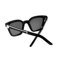 Black master flash glasses with blue light lenses from EXCLUSIVE EYES, INC, featuring sleek design and clear lens details.