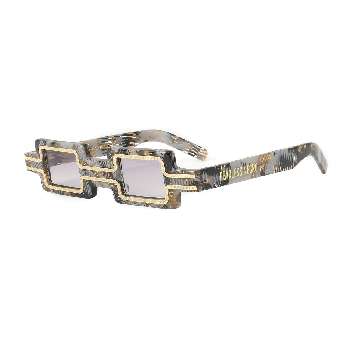 Close-up of the EXCLUSIVE EYES CREATOR sunglasses showing black frames and tinted lenses on a neutral background.