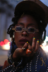 Close-up of the EXCLUSIVE EYES CREATOR sunglasses showing sleek black frames and tinted lenses.