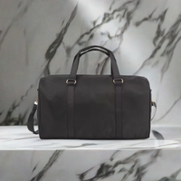 Black AdventureLight duffle bag by Fitkitty Culture, stylish accessory with sturdy handles and spacious interior for travel or gym use.