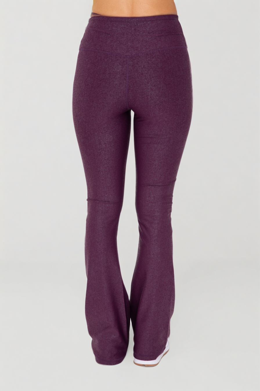 Black Luxe Edge leather-look crossover flare leggings by Fitkitty Culture, stylish women's athleisure and yoga clothing.
