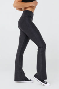 Black Luxe Edge leather-look crossover flare leggings by Fitkitty Culture, stylish women's yoga and athleisure wear.