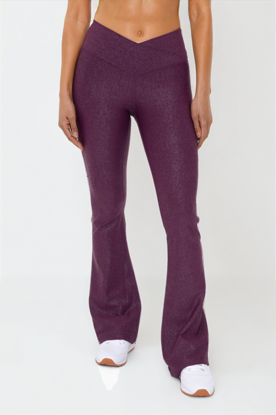 Black leather-look crossover flare leggings by Fitkitty Culture, stylish women’s athleisure and yoga clothing.