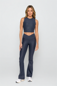 Black Luxe Edge leather-look crossover flare leggings from Fitkitty Culture women's yoga and athleisure wear, front view.