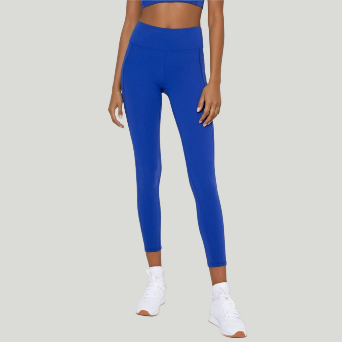 Blue cropped leggings with pockets from Fitkitty Culture Athleisure Wear, designed for yoga and active women’s clothing.