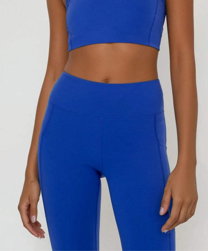 Blue cropped leggings with pockets from Fitkitty Culture Athleisure Wear, designed for comfortable yoga and active wear.
