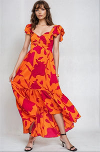 Vibrant Fire Floral high-low maxi dress by Fitkitty Culture, flowing fabric with bold floral pattern and sleeveless design.