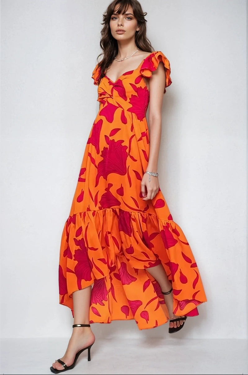 Vibrant Fire Floral high-low maxi dress by Fitkitty Culture features bold floral patterns and flowing fabric for women's clothing.