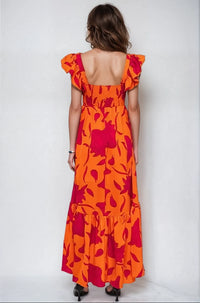 Vibrant Fire Floral high-low maxi dress by Fitkitty Culture featuring bold fiery floral pattern and flowing fabric.