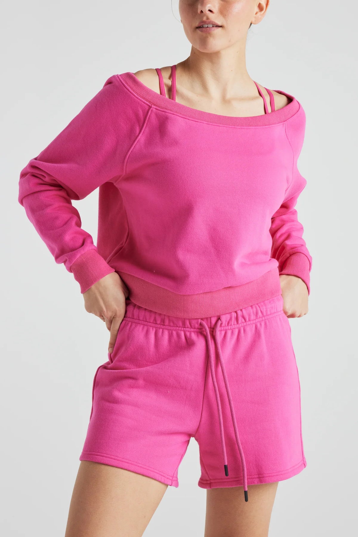 Pink off-shoulder sweatshirt by Fitkitty Culture, stylish women's athleisure clothing for casual and yoga wear.