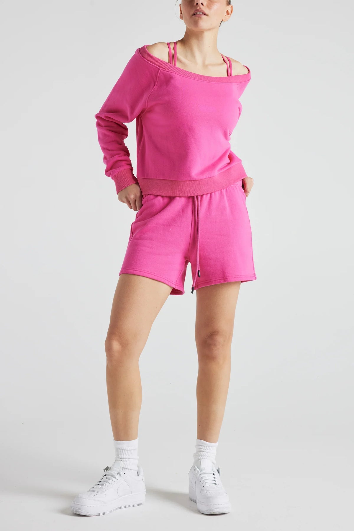 Pink off-shoulder sweatshirt from Fitkitty Culture athleisure wear, stylish women’s clothing perfect for casual or yoga outfits.