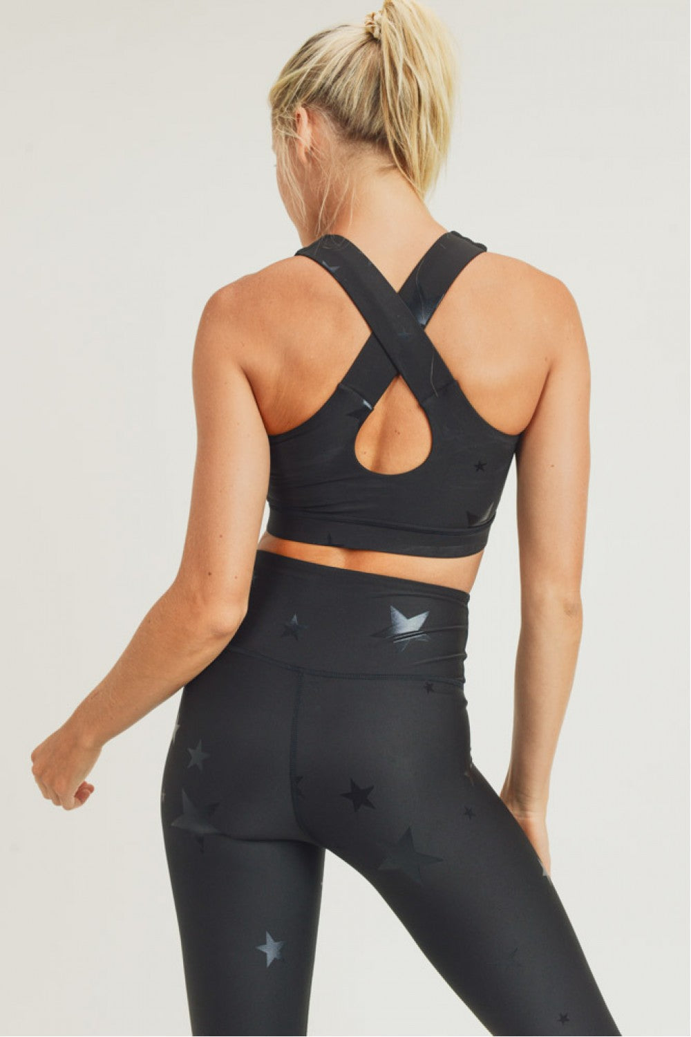 Black Fitkitty Culture Starlight Star Foil Sports Bra for women, featuring a sleek design and comfortable fit for active wear.