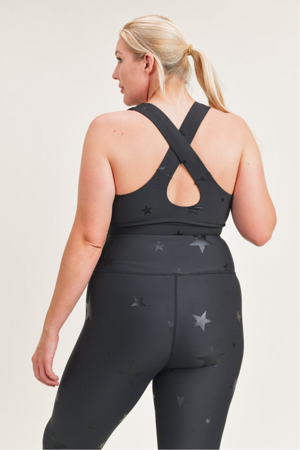 Black Starlight Star Foil Sports Bra by Fitkitty Culture, women’s athletic wear with shiny star accents, ideal for yoga and exercise.
