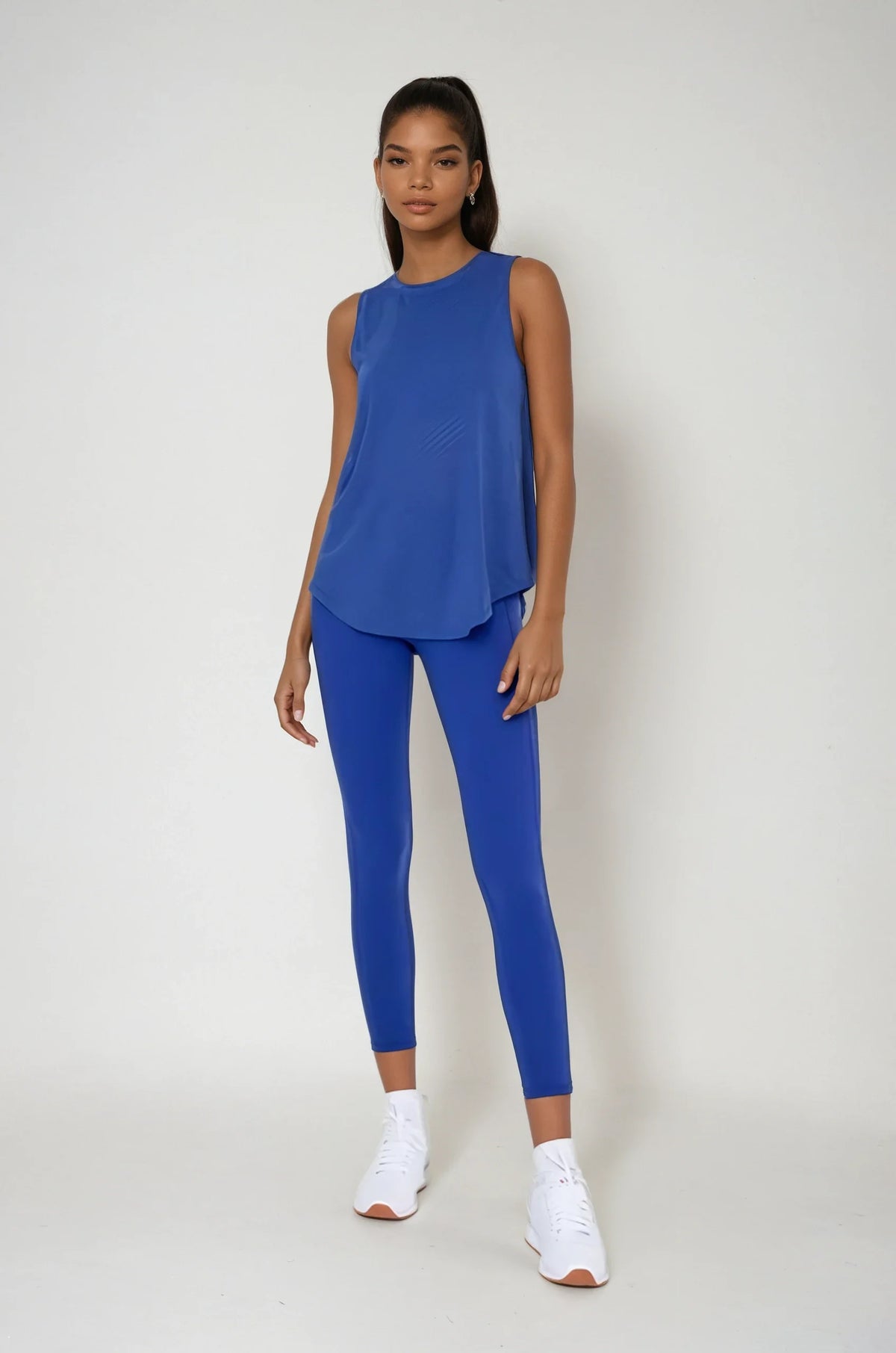 Blue sheer striped mesh active tank top with a cut-out back, designed for women’s yoga and athleisure by Fitkitty Culture.